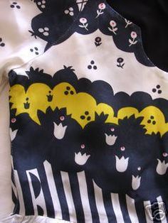 the back of a black and white shirt with yellow bats on it