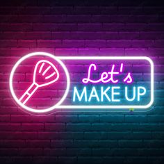 a neon sign that says let's make up with a spatula on it