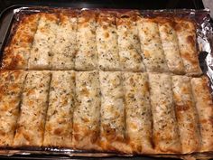 some food is sitting on top of tin foil and ready to be cooked in the oven