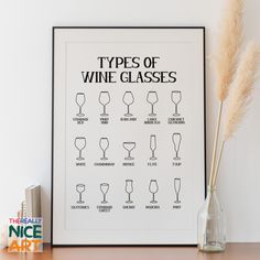 a wine glass chart on a table next to a vase with dry grass in it