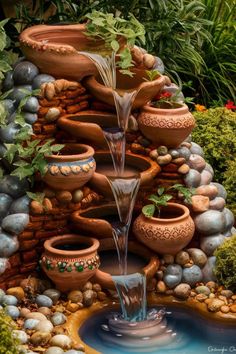 a water fountain surrounded by potted plants and rocks