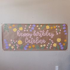 a happy birthday sign hanging on the wall