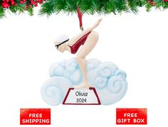 a christmas ornament with a woman doing yoga on top of snow flakes