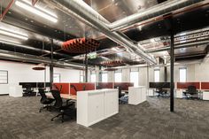 an empty office with red and white walls