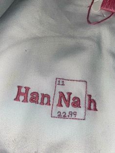 an embroidered shirt with the name han nah on it and a red thread in front