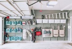 a garage with several storage bins and hanging baskets on the wall next to it