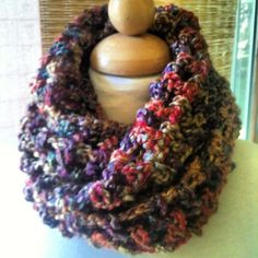 a crocheted cowl is sitting on a mannequin