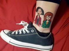 a woman's foot with an image of two women on the side of her leg