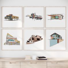 four framed architectural drawings hang on the wall above a wooden dresser in a white room