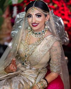 a woman wearing a bridal outfit and jewelry