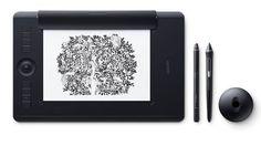 an electronic device with a drawing on the screen next to a pen and another item