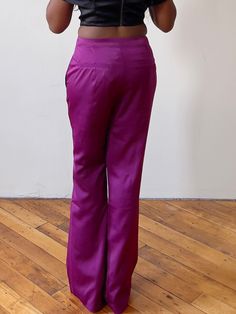 Why You'll Love It     Lightweight, unlined, and feminine wide-leg trousers feature functional pockets, a belt loop, and a tapered finish   Fit : Tapered. There is no stretch, so order your appropriate pants size/jean size when it comes to these pants.   Fabric : 95% Polyester, 5% Spandex   Care : Hand Wash Cold, Do not bleach, line dry, iron low heat    Model Specs:      Bust:  33"   Waist:  28"   Hips:  37"   Height:  5'4  Model is wearing a size MEDIUM    Size Guide:    Fit:    Fitted, there Elegant Purple Pants For Party, Elegant Purple Bottoms For Party, Elegant Purple Satin Bottoms, Elegant Purple Party Bottoms, Chic Fitted Satin Finish Bottoms, Chic Fitted Bottoms With Satin Finish, Formal Full-length Purple Bottoms, Formal Full Length Satin Wide Leg Pants, Full Length Purple Formal Bottoms