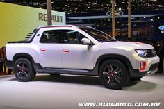 a white pick up truck on display at an auto show