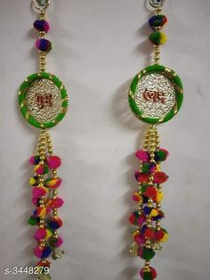 pair of earrings with colorful beads hanging from it's ear ends and the word love written in arabic