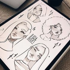 an image of a drawing on a table with various faces and hair styles in it