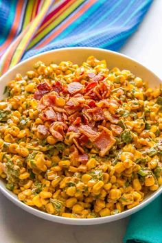 a white bowl filled with corn and bacon