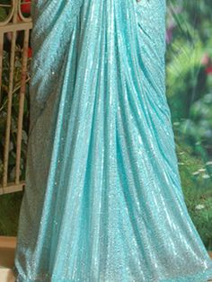 Ruffled saree has been a perfect garment that has always reflected a woman’s beauty and elegance! This figure flattering shimmer saree can be a perfect outfit for any event! Blouse sell separate! Color - Aqua Blue Fabric & Work Style - - Sequin - Plain Light blue Blouse work Size 34-38 Blouse from the Picture Sold Separately Details - - Assured quality. - Wash care instruction: Dry clean only. - Slight variation in color is possible due to digital photography. Glamorous Pre-draped Saree For Reception And Navratri, Glamorous Designer Pre-draped Saree For Navratri, Bollywood Style Floor-length Pre-draped Saree For Parties, Glamorous Floor-length Georgette Pre-draped Saree, Glamorous Floor-length Pre-draped Saree With Dupatta, Party Wear Pre-draped Saree With Floor-length Pallu, Glamorous Saree For Diwali With Traditional Drape, Floor-length Pre-draped Saree With Self Design For Party, Glamorous Pre-draped Saree With Zari Work