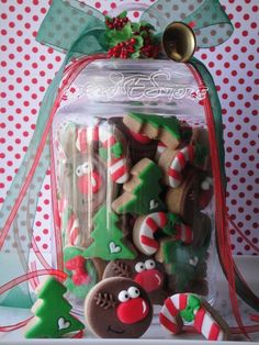 christmas cookies in a glass jar with ribbon