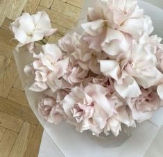 a bouquet of pink flowers sitting on top of an envelope