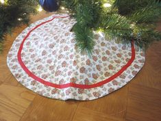 a christmas tree skirt sitting on top of a wooden floor