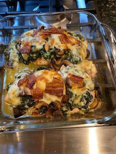 a casserole dish with spinach, bacon and cheese in it on a stove