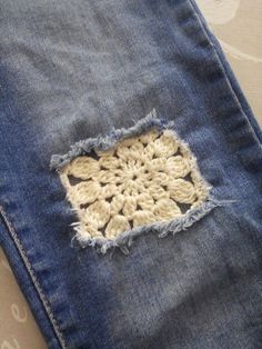 an old pair of jeans with crochet on them