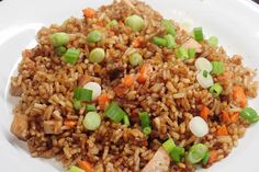 a white plate topped with brown rice and veggies