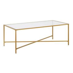 a coffee table with a glass top and gold metal frame, against a white background