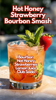 a drink with strawberries on the rim next to a swimming pool and text hot honey strawberry bourbon smash