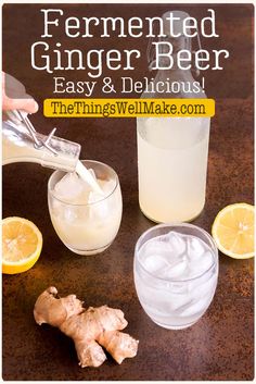 a person pouring ginger beer into a glass with ice and lemon slices on the side