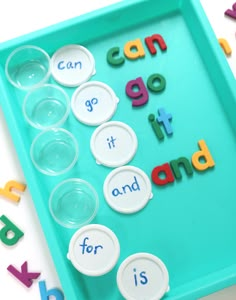 a tray with letters that spell out can't go it and is surrounded by plastic cups