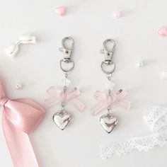 three pairs of heart shaped key chains with bows