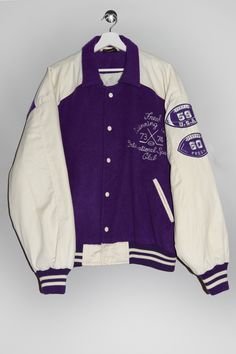 "Vintage 90's hockey warm varsity jacket in purple and creme-white with \"Fresh Winning Team 73/74 International Sporting Club\" embroidery at front and \"59 USA\" \"60 Fresh\" patches on the left sleeve. - Size tag: Please always check measurements before buying. Tag reads size 54, Men's L - Measurements (laying flat): Pit to Pit: 28\" Length: 28\" Sleeve: 24.5\" Pit to Cuff: 20\" Across the shoulders: 25\" -Wear: /Please see images for details/ Overall in good shape and vintage condition. Small stains at several places on the sleeves and the bottom buttons are a bit rusty as shown on the pictures. - Fabric: Acrylic Polyester Nylon *All of our items are preloved pieces so some signs of natural wear and age are to be expected. Please look through the photos carefully to check if the condit White Varsity Jacket With Embroidered Patch For College, White Varsity Outerwear With Embroidered Logo, White Embroidered Patch Outerwear For Streetwear, White Embroidered Patch Outerwear For College, White Embroidered Outerwear For Streetwear, Collegiate Varsity Jacket With Embroidered Patch For Winter, Collegiate Winter Varsity Jacket With Embroidered Patch, White Varsity Jacket With Embroidered Logo For College, White Varsity Jacket With Embroidered Logo For Winter