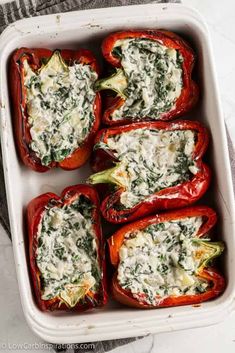 stuffed bell peppers with spinach and cheese in a casserole dish, ready to be eaten