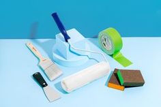 a blue table topped with different types of cleaning supplies