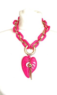 Bright pink, acrylic leaf and chain necklace from Olivia Divine. Chunky, pink acrylic chain necklace with gold tone metal chain detailing. Pink acrylic leaf pendant drop, with gold tone metal charms. Adjustable length. Handmade item. Pink Chunky Chain Jewelry For Party, Trendy Pink Chain Necklace With Adjustable Chain, Trendy Pink Necklace With Chunky Chain, Pink Chunky Chain Necklace As Gift, Pink Metal Chain Necklace With Adjustable Chain, Trendy Pink Chunky Chain Jewelry, Pink Metal Chain Necklace For Party, Trendy Pink Metal Necklace, Trendy Pink Chain Necklace