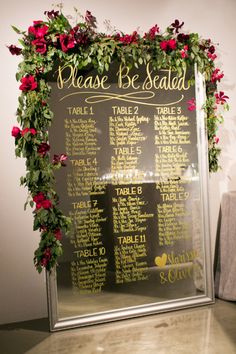 a wedding seating chart with flowers on it