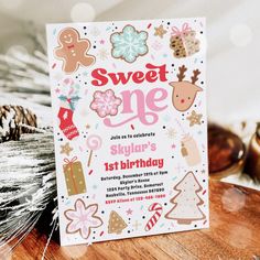 a sweet one year birthday party with gingerbread cookies and other holiday treats on the table