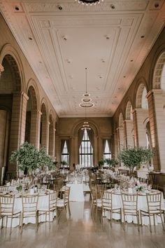 a large room with tables and chairs set up for a formal function in the middle of it