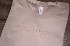 This custom embroidered neutral t-shirt is perfect for any mom, grandmother, gigi, aunt, mimi, or any special person.  It is a soft, high quality Bella Canvas t-shirt personalized with your choice of name, title or word.  Matching tone on tone thread will be selected for your t-shirt color.  Alternate colors can be used upon request.  Lettering will be your choice of all lowercase, all capitals or first letter capital and the remaining lowercase letters for your word.  If you are looking for a different shirt color, please contact me and we can work together to find the perfect color for you! T-SHIRT DETAILS This t-shirt is a soft, high quality unisex size Bella Canvas short sleeve shirt 100% airlume combed and ringspun cotton It is a roomy unisex size- please refer to the size chart CUSTO Capital Letter Fonts, Neutral T Shirts, Your Word, Grandmother Gifts, Embroidered Tshirt, Custom Embroidery, Lettering Fonts, Special Person, Grandma Gifts