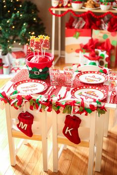 the table is decorated with red and green christmas decorations