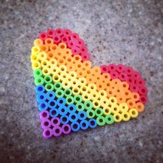 a heart shaped object made out of colored pegs