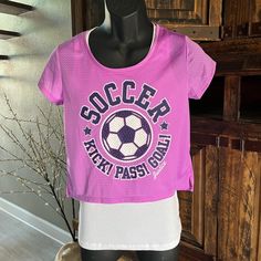 a mannequin wearing a pink shirt with soccer on it