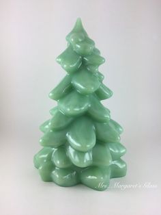 a green ceramic christmas tree on a white background