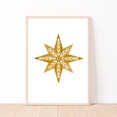 a gold and white snowflake print on a wooden floor next to a wall