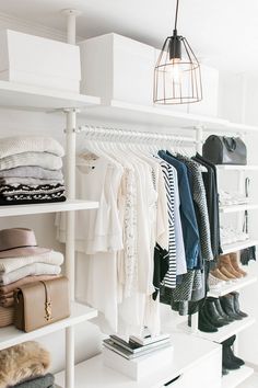 an organized closet with clothes and shoes on shelves