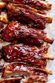 ribs covered in bbq sauce on top of parchment paper