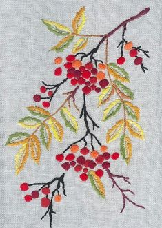 an embroidered piece with red berries and yellow leaves