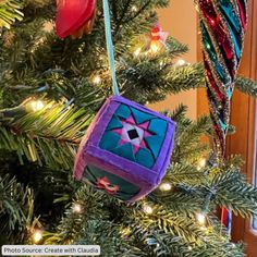 an ornament hanging from the top of a christmas tree