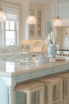 a kitchen island with stools in front of it and a vase on the counter